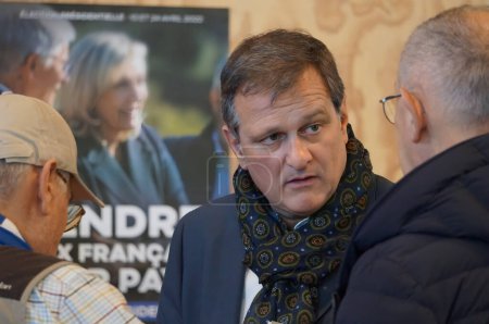 Foto de Reims, Francia - 5 de febrero de 2022 - Louis Aliot charlando, frente a un cartel de Marine Le Pen, en su Convención Presidencial; él es el alcalde de Perpiñán y un ex miembro de la Asamblea Nacional - Imagen libre de derechos