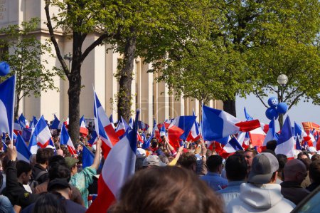 Photo for Paris, France - March 27, 2022 - Large crowd of presidential candidate Eric Zemmour's supporters, waving French flags, at his giant rally on the Trocadero Esplanade, behind the Chaillot Palace - Royalty Free Image