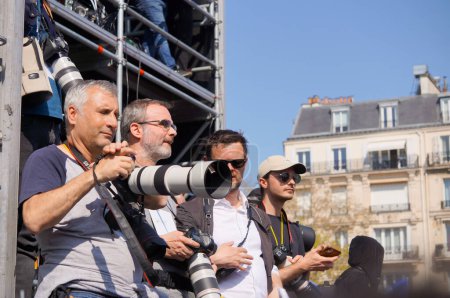 Photo for Paris, France - March 27, 2022 -Photographers on the scaffolding reserved for the press, with long lenses, covering French presidential candidate Eric Zemmour's giant rally on Trocadero Esplanade - Royalty Free Image