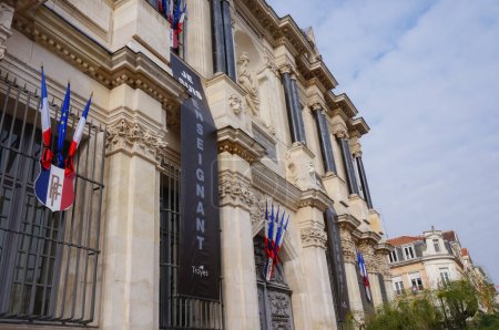 Photo for Troyes, France - Oct. 18, 2020 - All flags at half-mast and black banners, reading "I am a teacher", at the city hall, in homage to Samuel Paty, a history teacher beheaded by an islamist terrorist - Royalty Free Image