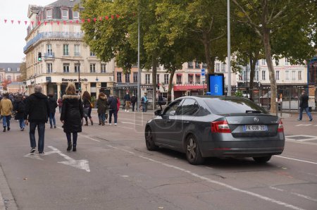 Photo for Troyes, France - Oct. 18, 2020 - An unmarked Skoda police vehicle with a blue flashing light, escorts the white march in Republic Street in homage to Samuel Paty, a teacher beheaded by a jihadist - Royalty Free Image