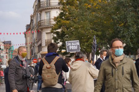 Photo for Troyes, France - Oct. 18, 2020 - Teachers with placards reading "I am a teacher" gathering in homage to Samuel Paty, a history teacher beheaded by a jihadist for showing Charlie's cartoons of Muhammad - Royalty Free Image