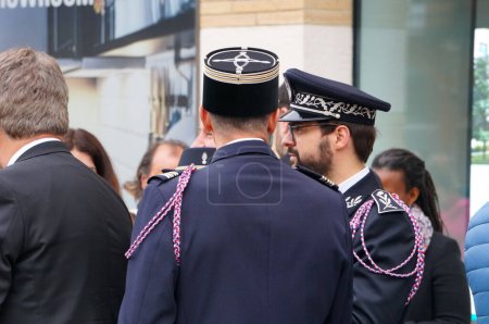 Photo for Toulouse, France - April 2023 - A firefighter lieutenant-colonel and a National Police commander, wearing dress uniforms with fourragere, attend the commemoration of the 1915 Armenian genocide - Royalty Free Image