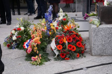Photo for Toulouse, France - April 2023 - Wreaths of colorful flowers laid on the floor, at the foot of the Memorial of the 1915 Armenian genocide by the Ottoman Empire during World War I, on Armenia Square - Royalty Free Image