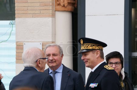 Photo for Toulouse, France - April 2023 - Mayor-president Jean-Luc Moudenc and Subprefect Serge Jacob, in dress uniform, have a chat on the street with an elderly constituent after an official ceremony - Royalty Free Image