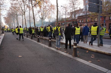 Photo for Albi, France - Dec. 2018 - Crowd of Yellow Vest ("Gilets Jaunes") protesters, blocking the main street of Albi during popular protests showing discontent about Emmanuel Macron's policy and government - Royalty Free Image