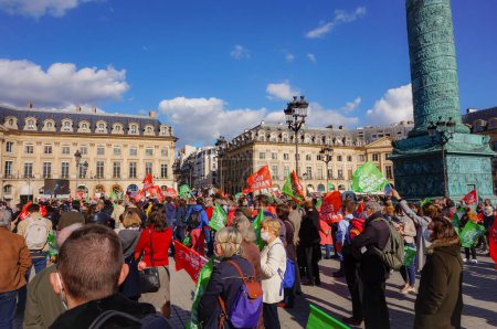 Photo for Paris, France - Oct. 10, 2020 - Cheering crowd of protesters at Marchons Enfants' demonstration against the bioethics bill, waving colorful flags in Place Vendme, in front of the Ministry of Justice - Royalty Free Image