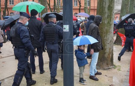 Photo for Toulouse, France - Jan. 30, 2021 - CRS (crowd control unit) police officers securing a pro family Marchons Enfants demonstration on Place du Salin, on the move to chase away Antifa disrupters - Royalty Free Image