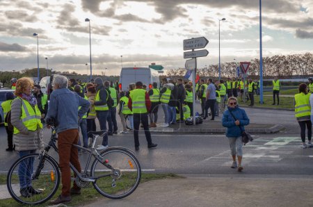 Photo for Albi, France - Dec. 2018 - Crowd of Yellow Vest ("Gilets Jaunes") protesters, blocking the main street of Albi during popular protests showing discontent about Emmanuel Macron's policy and government - Royalty Free Image