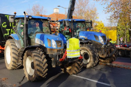 Photo for Albi, France - Dec. 1, 2018 - Farmers' tractors, trailer and crane in a roadblock hold by yellow vests protesters in Place Jean Jaures, at the start of the social movementl against Macron's tax policy - Royalty Free Image