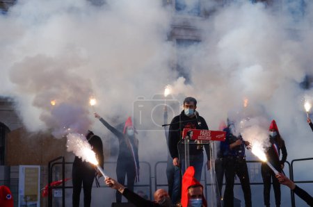 Photo for Paris, France - Oct. 10, 2020 - Young female activists of La Manif pour Tous wave smoke bombs at the end of their Vice-President Albric Dumont's speech against MAP without a father and surrogacy - Royalty Free Image