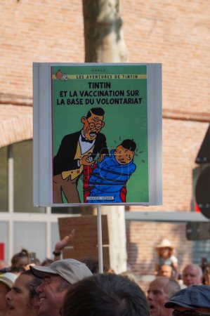 Photo for Albi, France - July 24, 2021 - Thousands of demonstrators protest against the French government's bill over vaccine mandate for health workers and sanitary passport with tintin banner - Royalty Free Image
