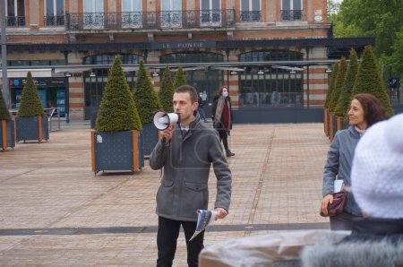 Photo for Albi, France - May 1, 2021 - Holding a loudspeaker, the Delegate of the Christian Democratic Party, together with Patriots' Delegate, gives a speech at a demonstration against sanitary restrictions - Royalty Free Image