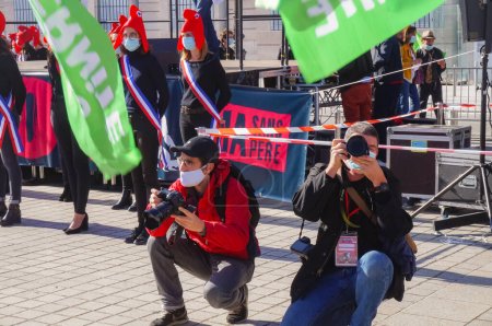 Photo for Paris, France - Oct. 10, 2020 - Press photographers crouching to shoot pictures at Marchons Enfants' manifestation in Place Vendme against the French government's bioethics and procreation bill - Royalty Free Image