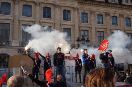 Photo for Paris, France - Oct. 10, 2020 - The "Mariannes" wave smoke bombs in front of the Ministry of Justice, in Vendme Square, at Marchons Enfants and LMPT's manifestation against the bioethics bill - Royalty Free Image
