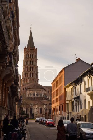 Photo for Toulouse, France - Jan. 2020 - The bell tower of the Basilica of Saint-Sernin, a medieval World Heritage Site and the largest romanesque church in Europe, in the perspective of Saint-Bernard Street - Royalty Free Image