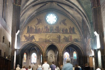 Photo for Toulouse, France - April 2021 - A catholic mass inside Notre-Dame du Taur Church, a 16th century building that features gothic vaults and a 19th century painted fresco depicting religious scenes - Royalty Free Image