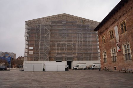 Photo for Toulouse, France - Feb. 2023 - Huge scaffolding against the Southwestern facade of the Romanesque, medieval Saint-Sernin's Basilica, a UNESCO World Heritage Site which undergoes restoration works - Royalty Free Image