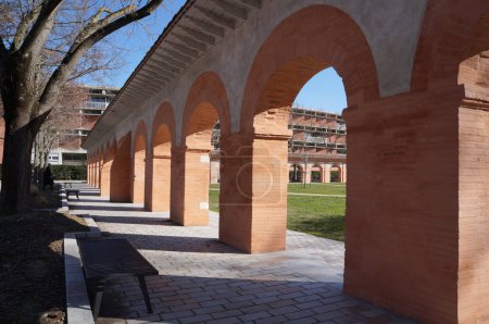Photo for Toulouse, France - Feb. 2023 - Historic brick arches of the 13th century medieval Chartreux cloister, surrounding the inner courtyard on Arsenal site, main campus of Toulouse Capitole University - Royalty Free Image