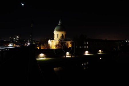 Photo for Night view of Saint-Joseph de La Grave's Chapel ; this famous landmark of Toulouse, France, built of brick in the 19th century, features a copper dome topped by a roof lantern and a triangular fronton - Royalty Free Image