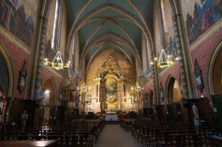 Photo for Toulouse, France - June 30, 2023 - Vaulted, 15th century nave with frescoed walls and ceiling lamps inside Saint-Nicolas', a Catholic church and a medieval, Southern Gothic landmark in Saint-Cyprien - Royalty Free Image