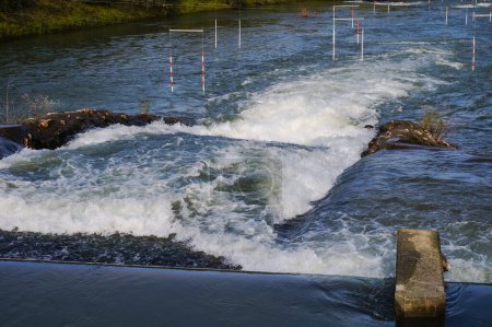 Photo for Water falls, rapids and powerful whirlpools with white foam on the River Garonne in Toulouse, France, seen from the passerelle of Chemin de la Loge between the islands of Grand Ramier and Empalot - Royalty Free Image
