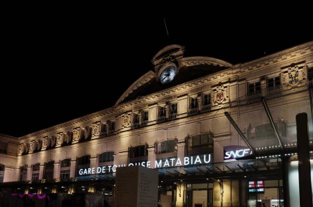 Photo for Toulouse, France - Aug. 2022 - Illuminated facade, by night, of Toulouse-Matabiau Station, with its lighted sign ; the infrastructure is the main train station and multimodal hub in Midi-Pyrenees - Royalty Free Image