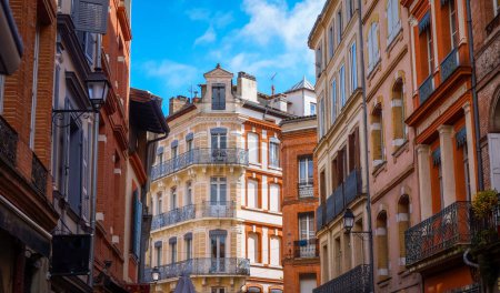 Photo for Brick colorful facades of old typical Southern houses in historic city centre of Toulouse, France - Royalty Free Image