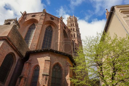 Photo for Exterior of the transept and low angle view of the brick bell tower of the Basilica of Saint Sernin, a UNESCO World Heritage site in Toulouse, France, and the largest romanesque church in Europe - Royalty Free Image