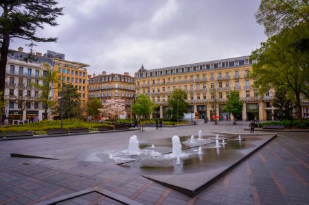 Photo for Toulouse, France - April 2019 - Water jets and fountain in Charles de Gaulle Square, bordered by big Haussmann-style apartment buildings, in the wealthy and comnercial neighborhood of Capitole - Royalty Free Image