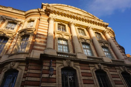 Photo for Back of the Capitole, city hall of Toulouse, France, featuring an imposing brick classic facade with massive columns, a balcony with balustrade and a fronton bearing the inscription "French Republic" - Royalty Free Image