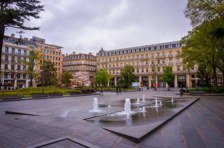 Photo for Toulouse, France - Sept. 2019 - Square Charles de Gaulle with its water jets and garden, behind the Capitole and closed by elegant cosy Haussmann-style apartment buildings of Alsace-Lorraine Street - Royalty Free Image