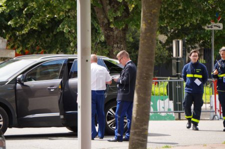 Photo for Toulouse, France - May 8, 2023 - Military staff members of the Director of Occitanie Region of Gendarmerie, by his official car, and paramedics of the Civil Security, amid Victory Day ceremony - Royalty Free Image