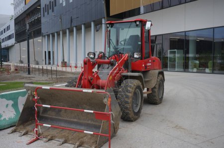 Photo for Toulouse, France - June 10, 2023 - A red, medium-size loading shovel from the rental company Loxam, on a construction site in front of the B612 Aerospace Valley HQ, on Montaudran Innovation Campus - Royalty Free Image