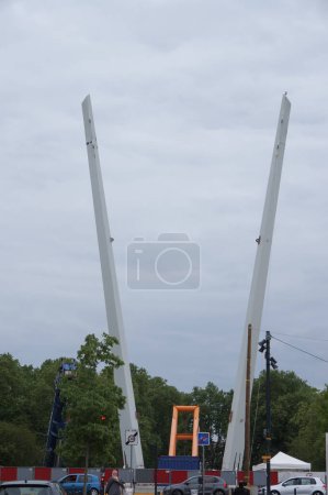 Photo for Toulouse, France - May 27, 2023 - V-shaped pylons of the future Empalot suspended footbridge, under construction; the walkway is to link Empalot District to Ramier Islands, crossing the Garonne River - Royalty Free Image