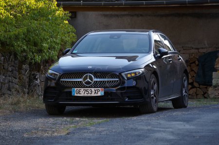 Photo for Occitanie, France - Aug. 14, 2023 - Front view of a black, 2018 Mercedes-Benz A Class; the A Class is a compact executive car produced by German manufacturer Daimler, that uses French Renault motors - Royalty Free Image