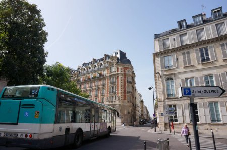 Téléchargez les photos : Paris, France - 5 septembre 2023 - Paysage urbain dans le 6ème arrondissement de la capitale, avec des maisons de ville typiquement parisiennes : un bus de la RATP circule dans la rue, en passant par la place Saint-Sulpice - en image libre de droit