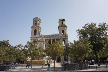 Photo for Paris, France - Sept. 5, 2023 - Main facade and round bell towers of the 17th century, Baroque church of Saint-Sulpice in the 6th arrondissement, seen from the leafy square of Place Saint-Sulpice - Royalty Free Image