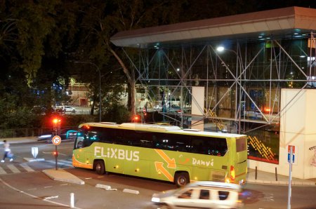 Foto de Toulouse, Francia - 4 de septiembre de 2023 - Un autobús Flixbus sale por la noche desde la Gare routire Pierre Smard, junto a la estación de tren de Matabiau, una terminal de autobuses urbanos, autocares nacionales e internacionales. - Imagen libre de derechos