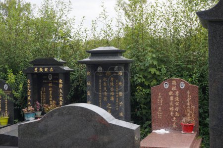 Photo for Thiais, France - Sept. 11, 2023 - Marble funerary monuments in the Asian parts of the Parisian Cemetery of Thiais, in Val-de-Marne, featuring Chinese characters and a typical, Oriental style - Royalty Free Image