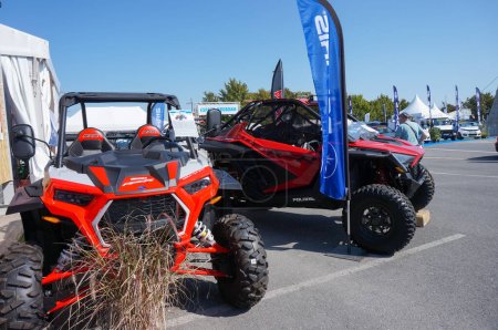 Photo for Chlons-en-Champagne, France - Sept. 9, 2023 - Two red light all-terrain vehicles (ATVs or quads) produced by US automotive manufacturer Polaris, exhibited at the 2023 industrial fair of Chlons - Royalty Free Image