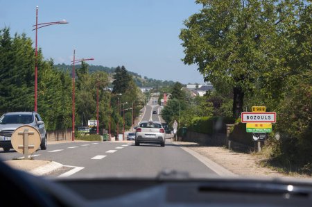 Foto de Bozouls, Francia - 14 de agosto de 2023 - "Route de Rodez" (Rodez Road) o Department Road RD988 a la entrada de Bozouls: este pueblo en Grands Causses, Aveyron, es conocido por la parte construida en el cañón - Imagen libre de derechos