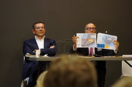 Photo for Toulouse, France - Nov. 15, 2023 - Sitting next to Nicolas Bonleux, Chairman of Lignes Droites, ex-district attorney Patrice Michel shows a report of the Air and Border Police on irregular immigration - Royalty Free Image