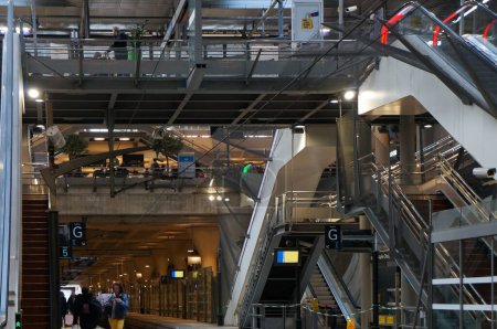 Foto de Chessy, Francia - 21 de noviembre de 2022 - Escaleras, pasarelas y escaleras mecánicas conectan las plataformas de tren juntas, en la estación de tren Marne-la-Valle-Chessy; sirve al conocido parque temático Dysneyland Paris - Imagen libre de derechos