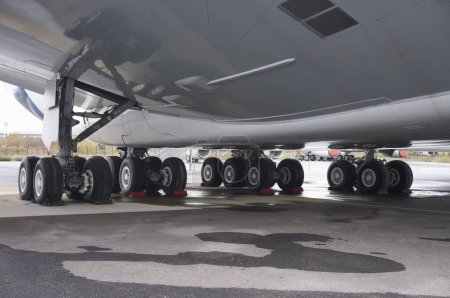 Photo for Toulouse, France - Nov. 21, 2023 - Wheels of the landing gear, under the belly of an AIrbus A380 parked on the tarmac; the undercarriage and tires are made by French manufacturers Safran and Michelin - Royalty Free Image