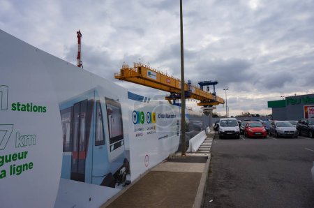 Photo for Labge, France - Dec. 2, 2023 - Girder launcher for the building of the viaduct for the extension of Toulouse's metro Line B; on the construction barrier, an information board presents the project - Royalty Free Image