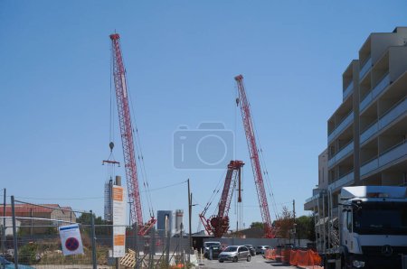 Photo for Toulouse, France - Aug. 9, 2023 - Crawler cranes and power shovel on the construction site of Montaudran Gare Metro Station on the future Tisso Line C, at the current Montaudran Railway Station - Royalty Free Image