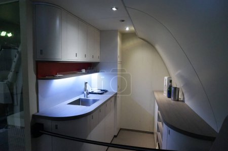 Photo for Toulouse, France - Nov. 21, 2023 - Fitted kitchen with modern furniture and neon lighting inside an Airbus A380 jumbo jet, exhibited at the aeronautical museum Aeroscopia - Royalty Free Image