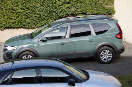 Photo for Aveyron, France - Feb. 10, 2024 - Side of a "khaki lichen" green Dacia Jogger, in a parking lot; it is a 2024 estate car, MPV produced in Romania by French automotive manufacturer Renault-Nissan - Royalty Free Image