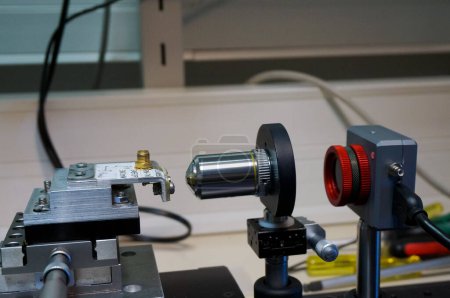Photo for Toulouse, France - March 7, 2024 - Experimental setup on an optical bench at ISAE-SUPAERO engineering school: a VCSEL laser diode mounted on a travel stage is analysed with a camera, through a lens - Royalty Free Image